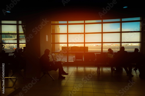 silhouette of Travel tourist of young man in sitting in the airport