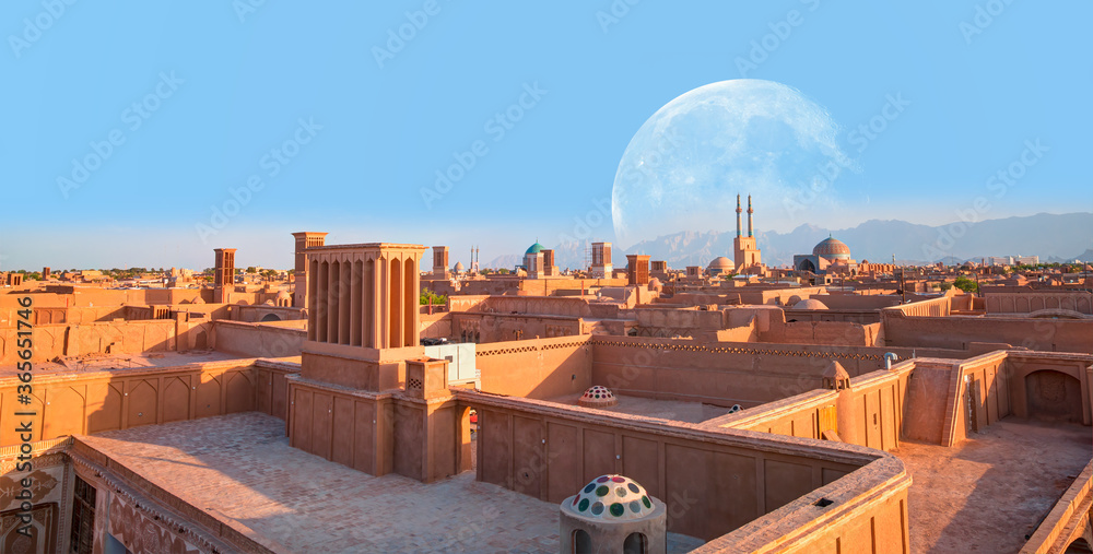 Historic City of Yazd with famous wind towers in the background full moon - YAZD, IRAN 