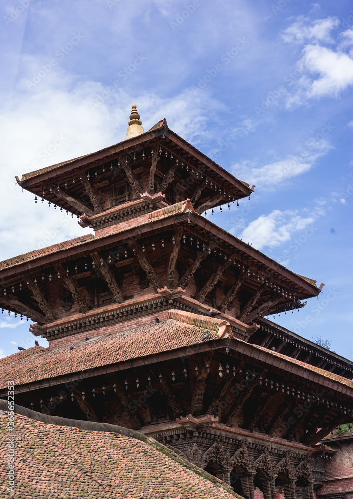 Buddhist and Hindu Temple in Nepal at Patan Durbar Square at a sunny clear day with blue sky, sightseeing Kathmandu Valley