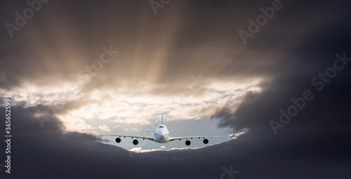 Commerical airplane flying under the storm clouds