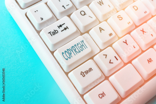 Writing note showing Copyright. Business concept for exclusive legal right to print write perform film record literary Pc keyboard key with empty note paper above background copy space