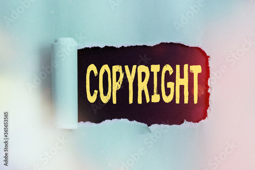 Word writing text Copyright. Business photo showcasing exclusive legal right to print write perform film record literary Rolled ripped torn cardboard placed above a wooden classic table backdrop