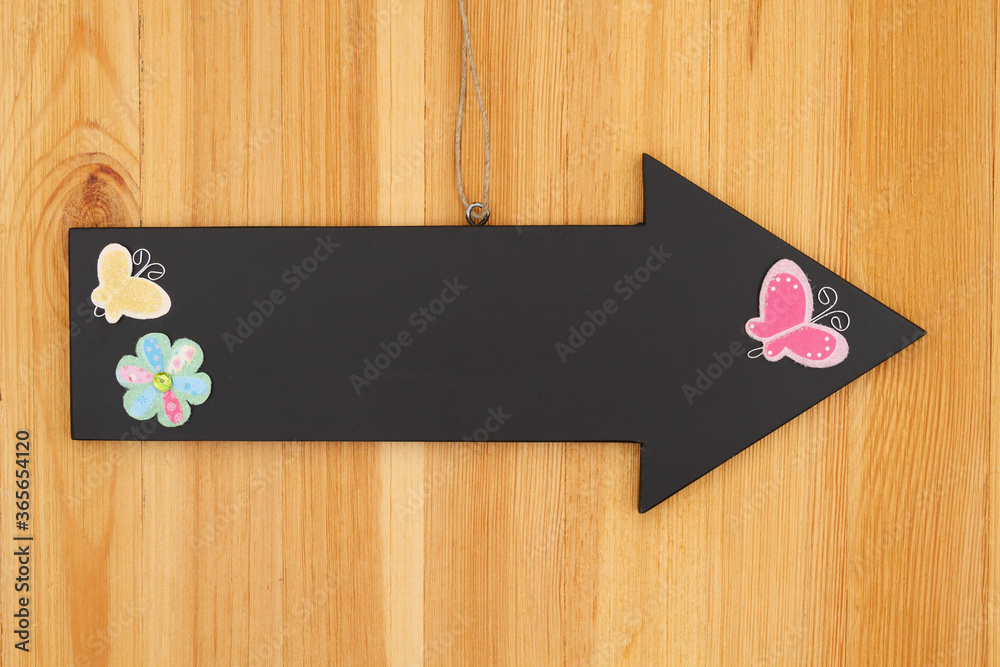 Spring blank hanging arrow chalkboard sign with a flower and butterfly sign on wood