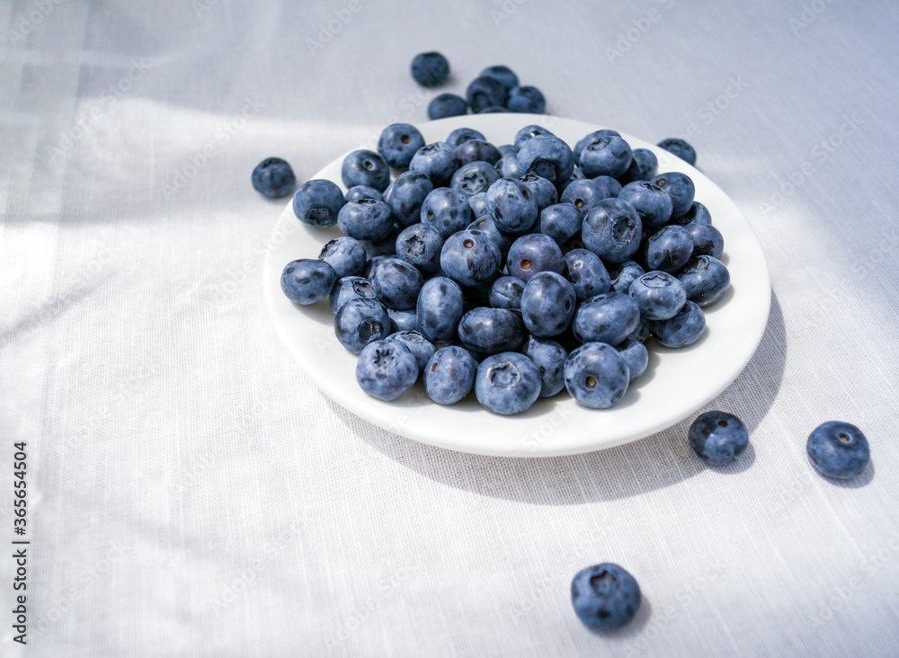 Blueberries on a small plate. Berries on the table. Blueberries on a small plate. Berries on the table.