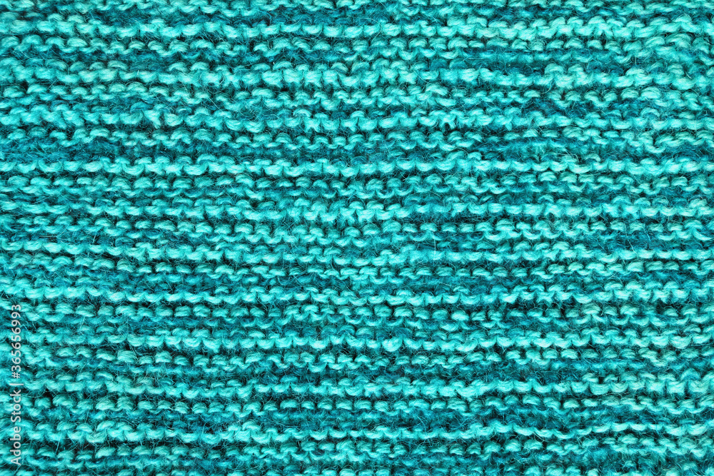 Blue-green background, homemade wool knitted texture