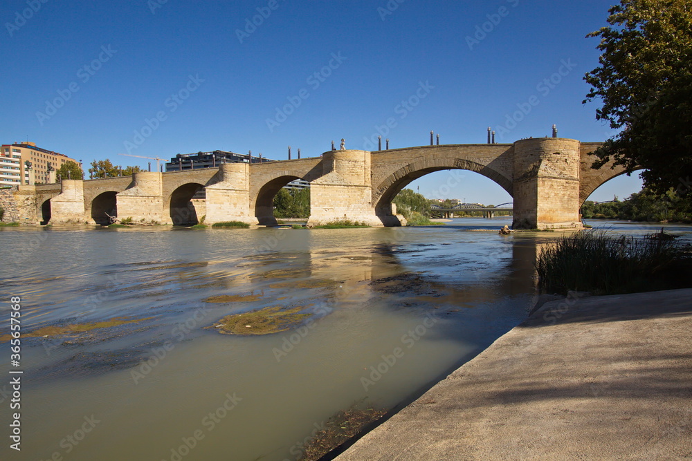 Stone bridge Puente de Piedra over the river Ebro in Zaragoza,Spain,Europe
