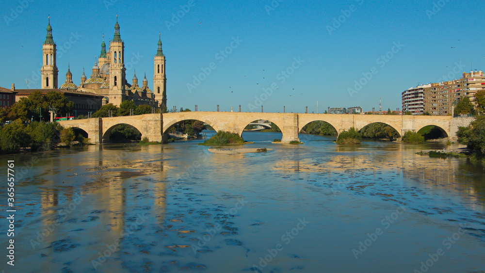 Cathedral-Basilica of Our Lady of the Pillar and stone bridge Puente de Piedra over the river Ebroin in Zaragoza,Spain,Europe
