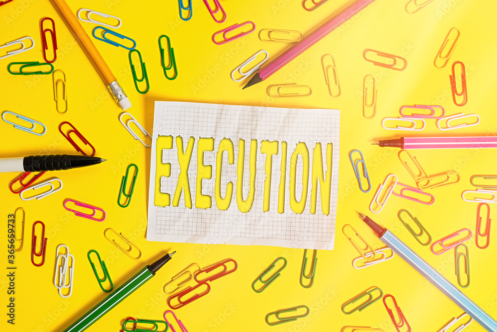 Writing note showing Execution. Business concept for it executes or imposes a program order or course of action Flat lay above empty paper with pencils and paper clips Writing note showing Execution. Business concept for it executes or imposes a program order or course of action Flat lay above empty paper with pencils and paper clips