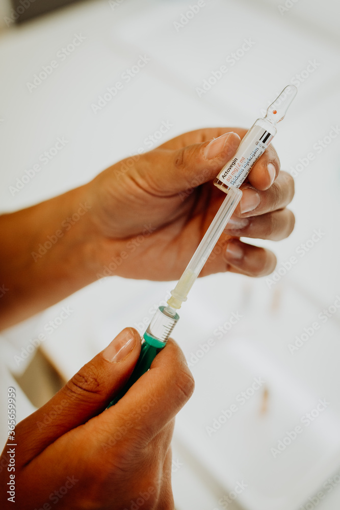 ampoules and needles on a tablet in a hospital, preparation of needles to be filled with medicine, close up of hands preparing a needle with medication
ampoules and needles on a tablet in a hospital, preparation of needles to be filled with medicine, close up of hands preparing a needle with medication