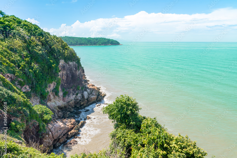 Koh Proet Island, The atmosphere on an island with mountains and trees amid the emerald green sea and the clear sky.