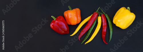 Wallpaper Mural Peppers and chillis on black slate, header Torontodigital.ca