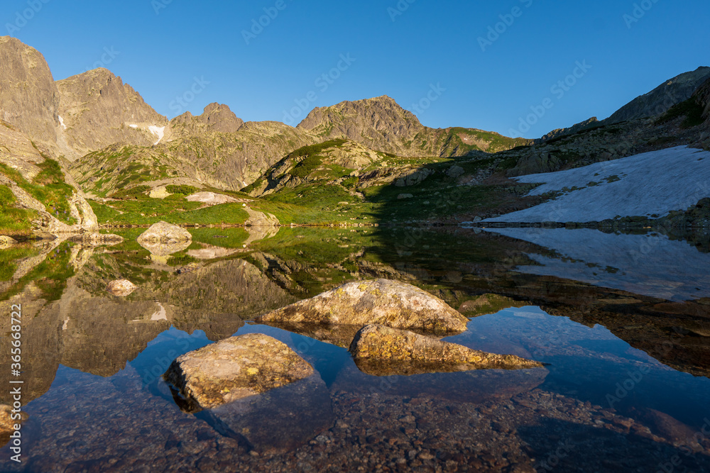 Wonderful spring sunrise of sesterske pleso . Amazing morning view of Tatras mountains. Slovakia, Europe. Beauty of nature concept background.