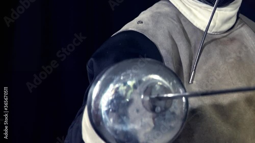 Fencing class in epee for women. Sport girl fence with her coach attacks in hand maestro individual lesson close up. photo