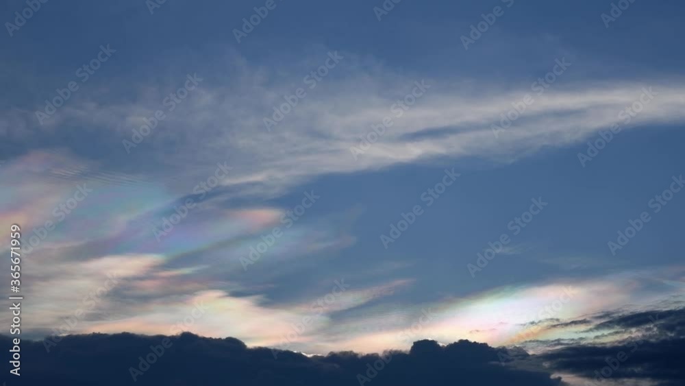 Time lapse motion The beauty of the rainbow clouds Above the black clouds moving fast on the sky in the evening. Time lapse motion The beauty of the rainbow clouds Above the black clouds moving fast on the sky in the evening.