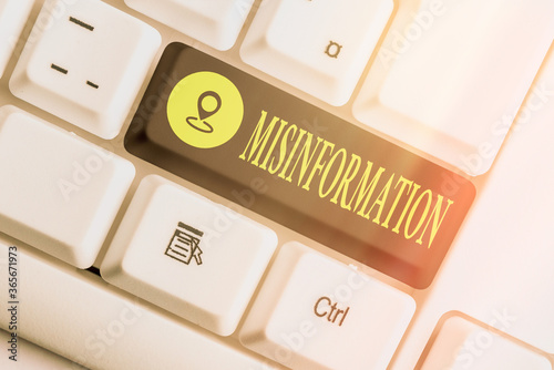Writing note showing Misinformation. Business concept for false data, in particular, intended intentionally to deceive Colored keyboard key with accessories arranged on empty copy space