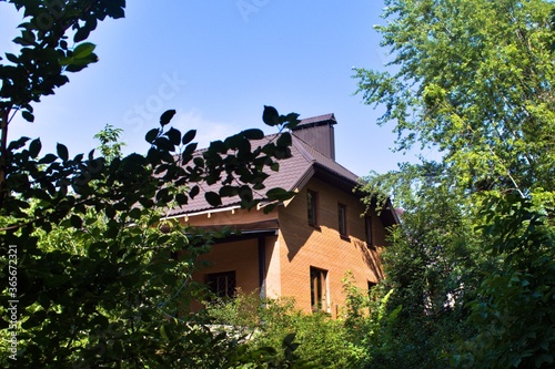 Photography brick house in forest on blue sky background