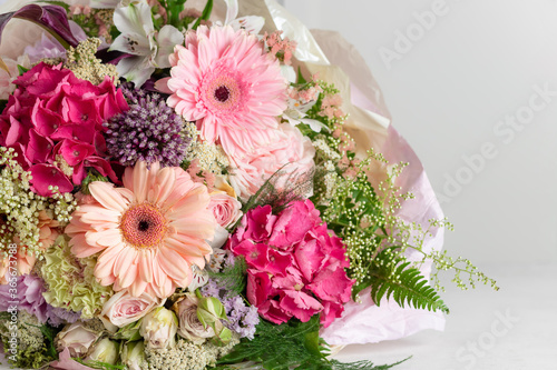 bright bouquet of gerbera, hydrangea, rose, alstroemeria flowers on a white background. flower arrangement. place for text. close-up