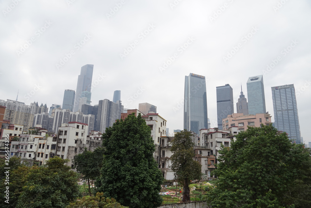 City skyline with an interesting cloudy sky behind. Panorama of full skyline with all the towers and buildings.