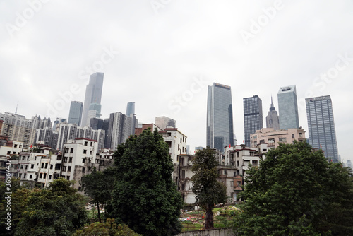 City skyline with an interesting cloudy sky behind. Panorama of full skyline with all the towers and buildings. © Sergey