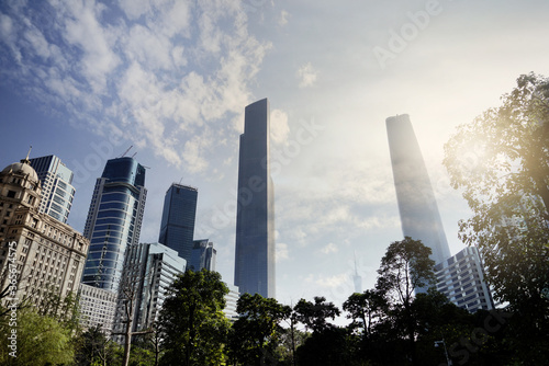 City skyline with an interesting cloudy sky behind. Panorama of full skyline with all the towers and buildings.