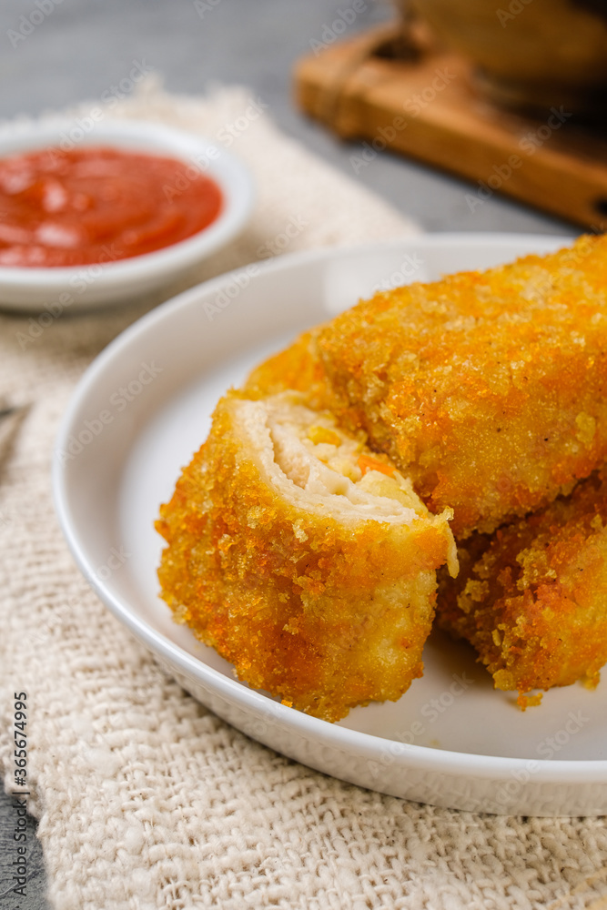 Delicious Risoles or Risol Mayo is a typical Indonesian traditional street food made from flour skin, meat and vegetables stuffing inside with mayonnaise and chili sauce.