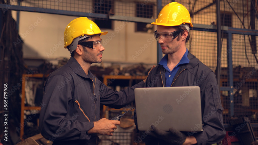 Two engineering in production plant as team discussing Two engineering in production plant as team discussing