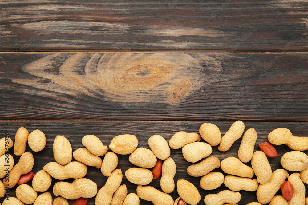 Peanuts in shells on brown background with copy space Peanuts in shells on brown background with copy space