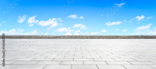 Fototapeta Naklejka Na Ścianę i Meble -  Empty square floor and blue sky with white clouds scene.