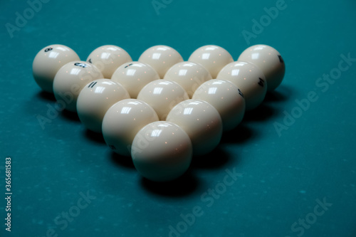 Pyramid, balls placed on a pool table tightly to each other in the form of an equilateral triangle front view from the top