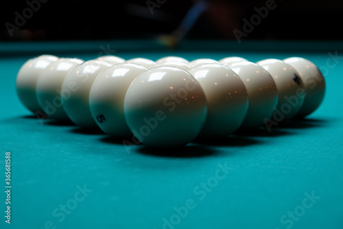 Pyramid, balls placed on a pool table tightly to each other in the form of an equilateral triangle front view