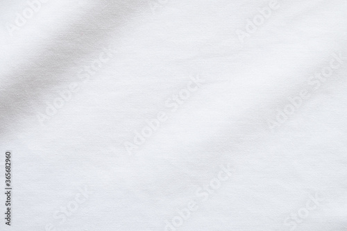 Top view close up shot of white fabric cotton shirt with woven gradient detail. Background and wallpaper concept. © BritCats Studio