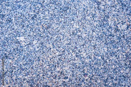 Beautiful stone granite background - polished stone surface with grainy texture with grains of blue, purple, pink color