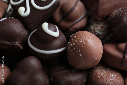 Different tasty chocolate candies as background, closeup