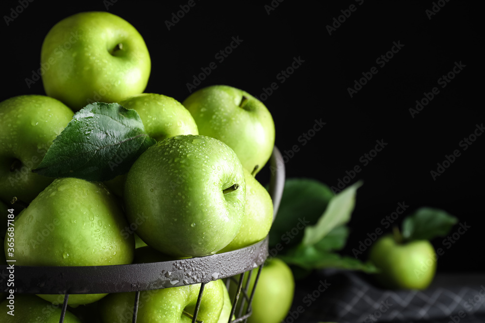 Juicy green apples in metal basket on black background, closeup Juicy green apples in metal basket on black background, closeup