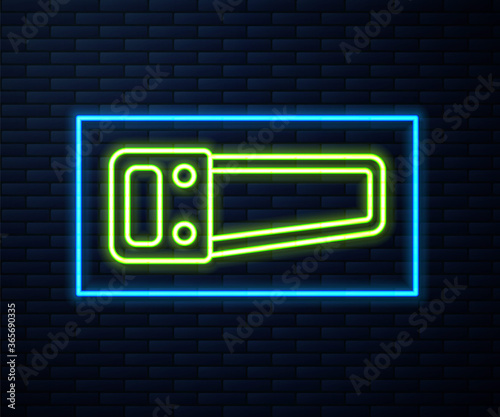 Glowing neon line Hand saw icon isolated on brick wall background. Vector Illustration.