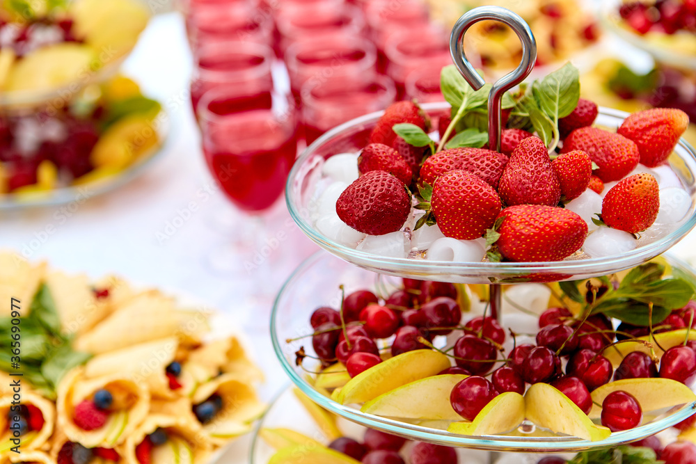 Close-up plate with berries, strawberries. raspberries, cherries, blueberries, and baked goods. Buffet table at the festival. Catering concept. Close-up plate with berries, strawberries. raspberries, cherries, blueberries, and baked goods. Buffet table at the festival. Catering concept.