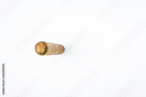 Long thick cigar from twisted sheets on white background.