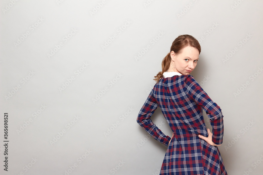 Portrait of angry disgruntled girl holding arms on hips Portrait of angry disgruntled girl holding arms on hips