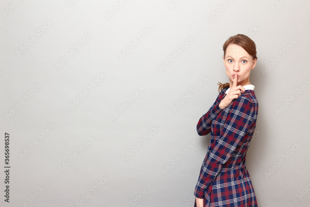 Portrait of girl showing silence gesture with finger over lips Portrait of girl showing silence gesture with finger over lips