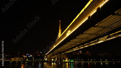 Golden Horn Metro Bridge in Istanbul at night, black sky and sea, Gold color reflection, background photo