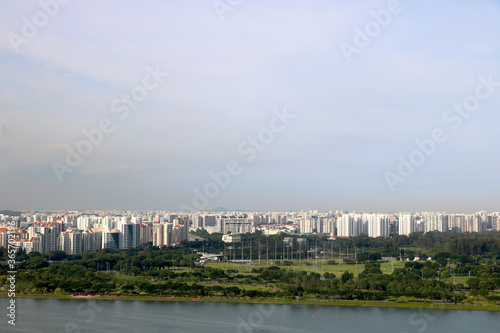 city view of singapore with condominium , HDB building and trees with background of blue sky