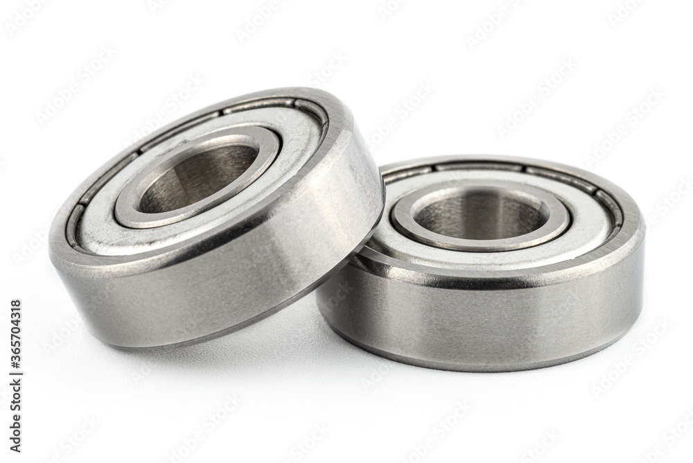 Macro shot of two ball bearings, isolated on a white background, selective focus. Macro shot of two ball bearings, isolated on a white background, selective focus.