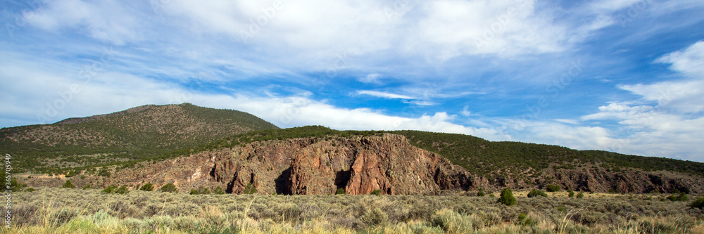 Ultrawide panorama of the walls of the Rio Grande Gorge in Rio Grande del Norte National Monument in New Mexico