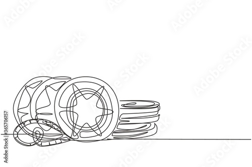 Single continuous line drawing stack of retro old classic film video reels. Vintage movie filmstrip item concept one line draw graphic design vector illustration