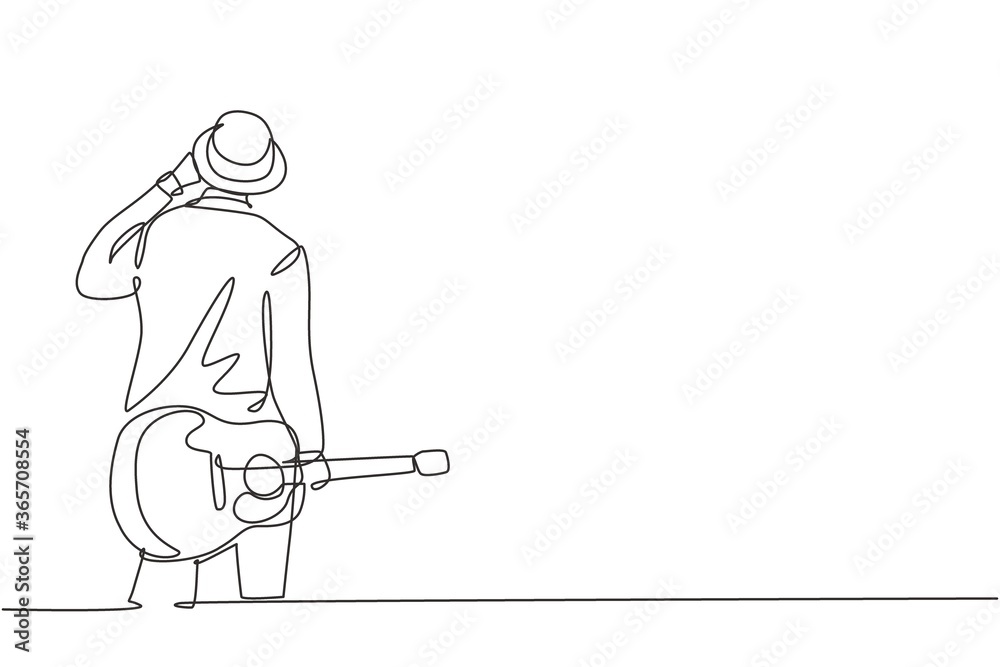 One continuous line drawing of young happy male guitarist wearing hat and holding acoustic guitar on his hand. Modern musician artist concept single line draw graphic design vector illustration