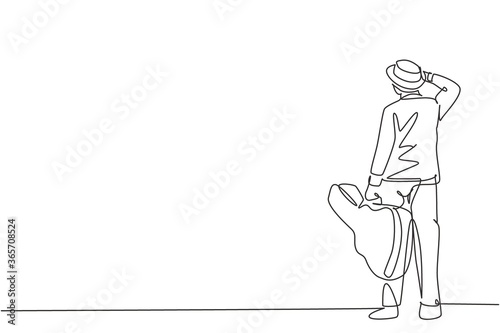 One single line drawing of young happy male guitarist standing and holding acoustic guitar case. Dynamic musician artist concept continuous line graphic draw design vector illustration