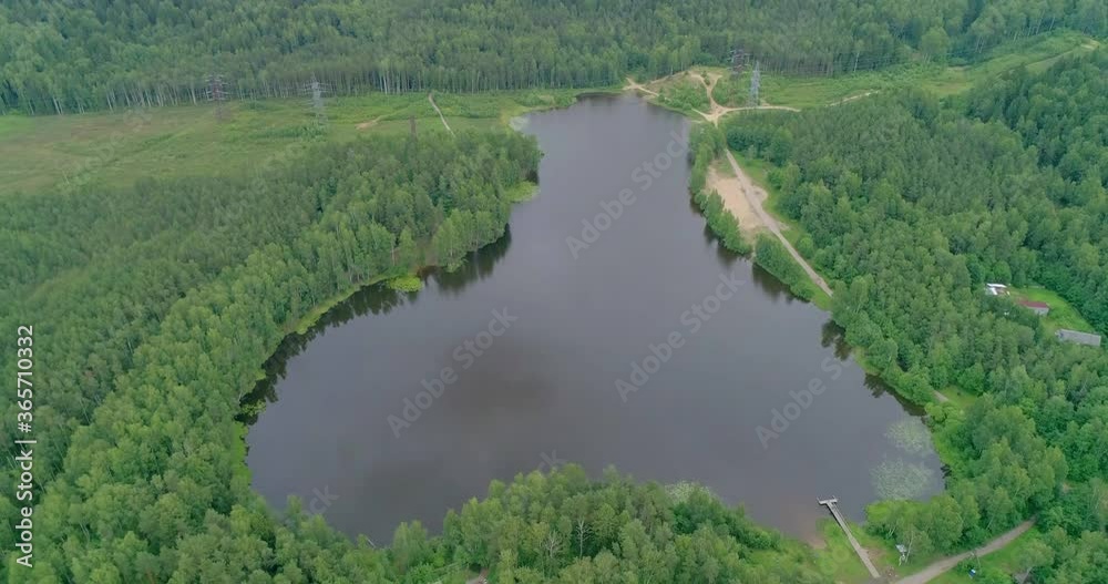 Flying over a beautiful forest lake on a summer day.
Flying over a beautiful forest lake on a summer day.