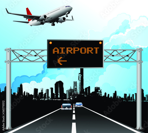 Roadway overhead gantry sign with passenger airplane taking off from nearby airport with blue cloudy sky 