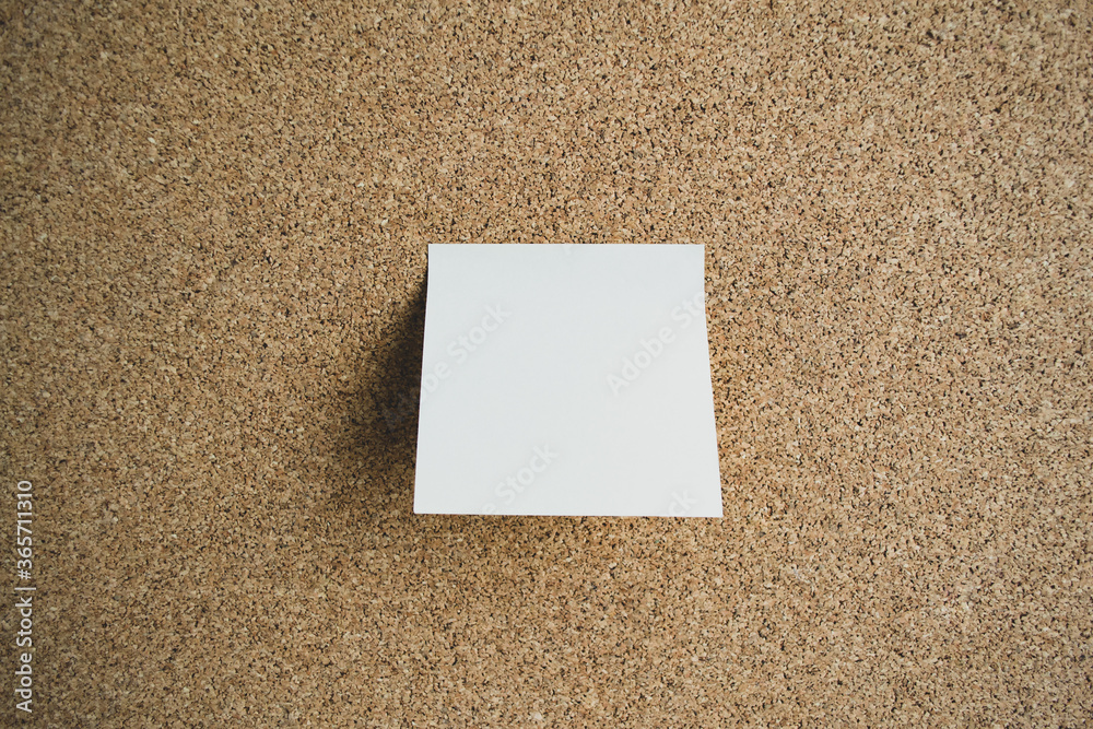 White sticky note paper on a cork board. Copy space White sticky note paper on a cork board. Copy space