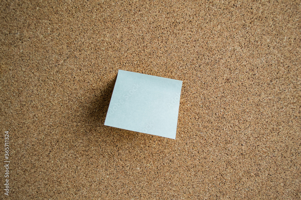 White sticky note paper on a cork board. Copy space White sticky note paper on a cork board. Copy space